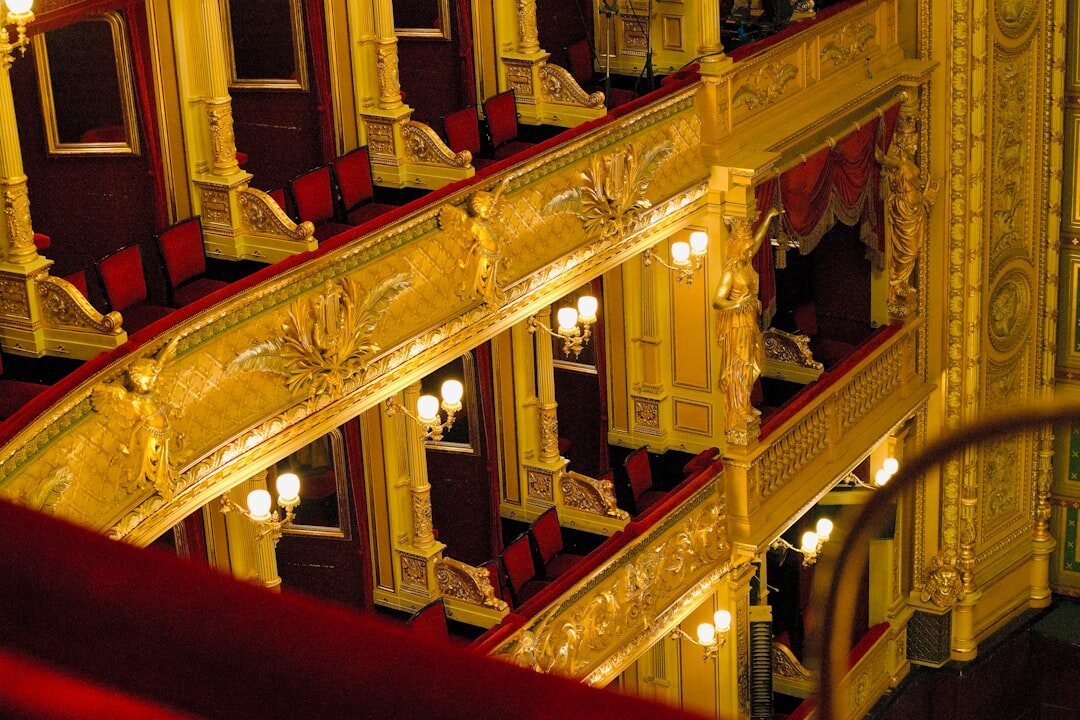 Detalle arquitectónico interior de un teatro de ópera clásico con dorados y terciopelo